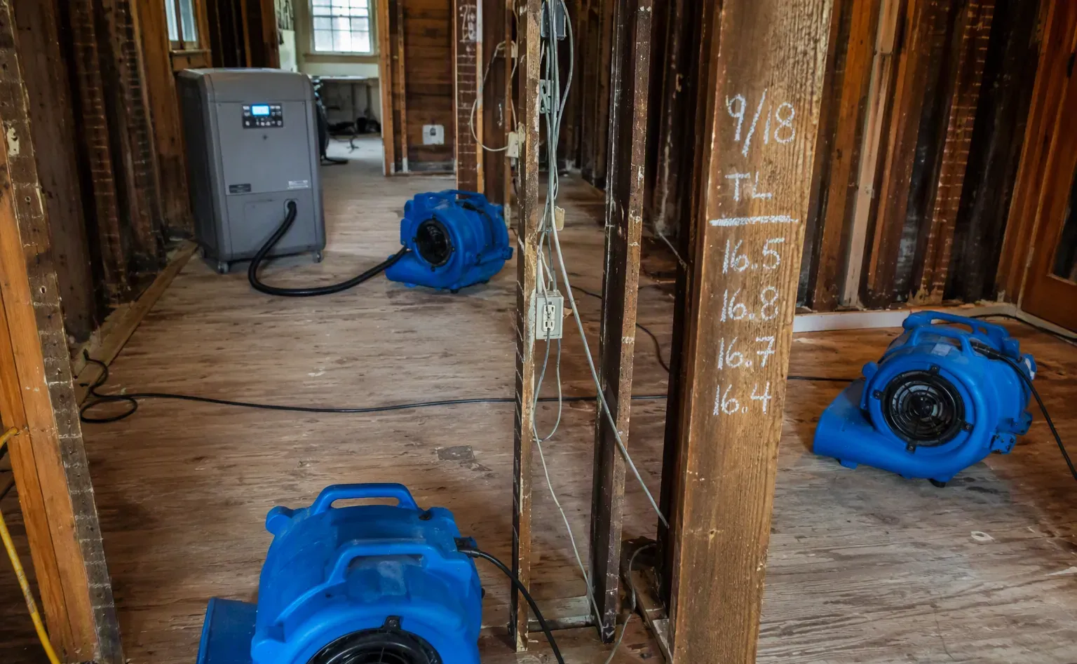 Plumber repairing supply lines under a sink